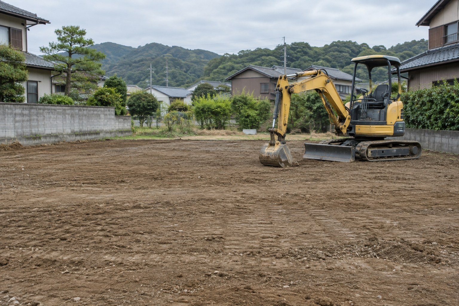 重機と平らに整えた土地のイメージ